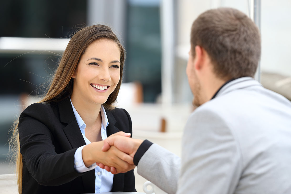 Woman shaking a man's hand